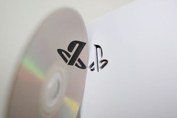 Physical disc and PlayStation 5 console are seen in this illustration photo