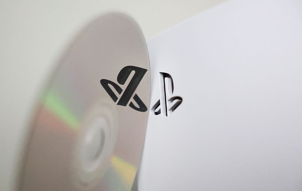 Physical disc and PlayStation 5 console are seen in this illustration photo