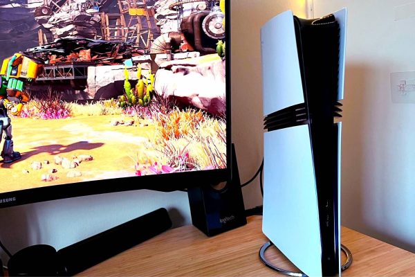 PS5 Pro next to monitor with Ratchet and Clank: Rift Apart gameplay on screen