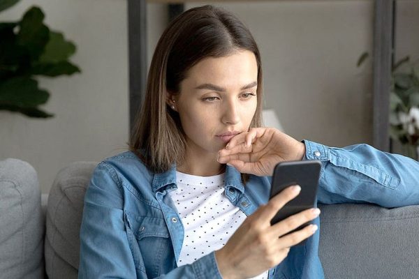 woman smartphone sofa home