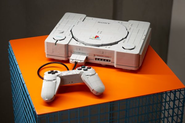 Lego PlayStation and controller on an orange surface