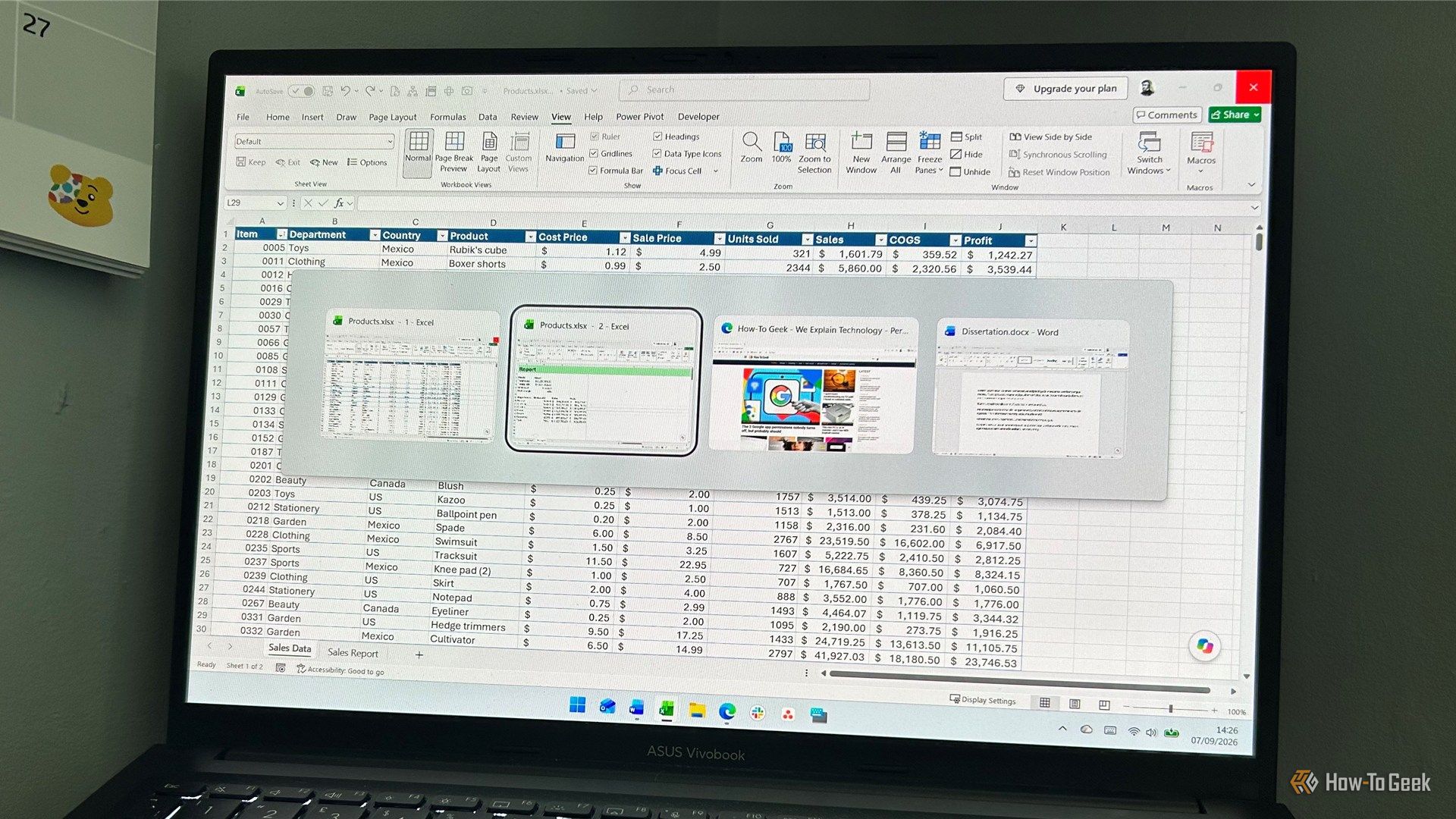 laptop screen showing the windows 11 task switcher with four open windows including two separate windows of the same microsoft excel workbook