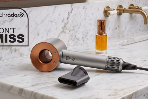 Dyson Supersonic Origin hair dryer laying flat on a marble vanity unit.